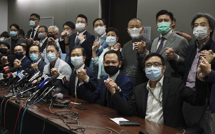 Hong Kong lawmakers resigning.