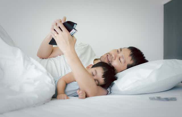 Unemployed stress asian man is hugging his baby on the bed and looking the wallet to find the money to pay for the expense and loan , concept of impact of covid 19 to personal financial problem.