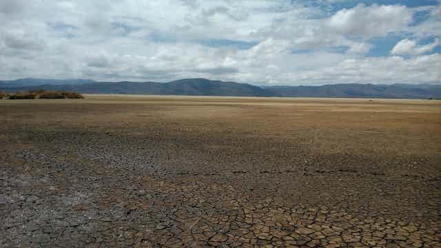 Dry lake bed with mountains in the distance.