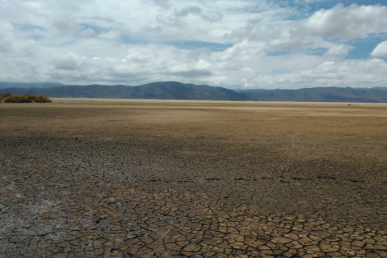 Dry lake bed with mountains in the distance.