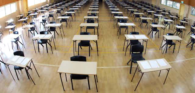 Empty exam hall with tables and chairs