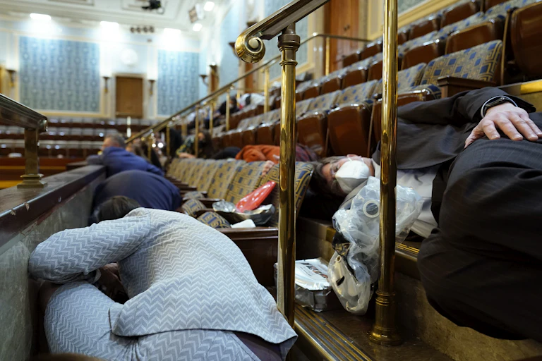 Lawmakers duck and cover in the U.S. Capitol.
