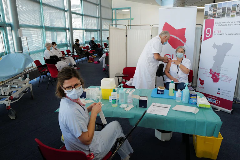 Des personnels médicaux vaccinent dans un centre dédié à la vaccination.