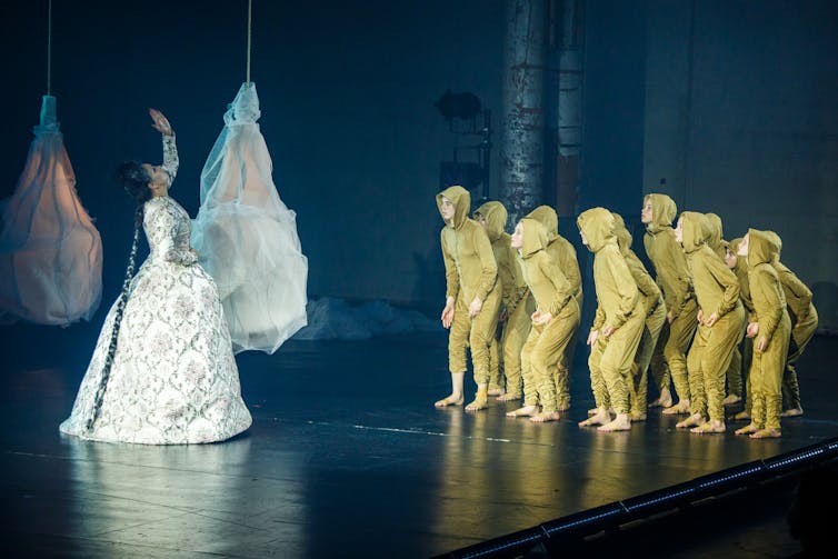 Rabe directs the children dressed in yellow.