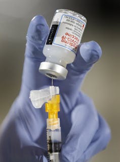 A nurse readies a COVID-19 vaccine jab.