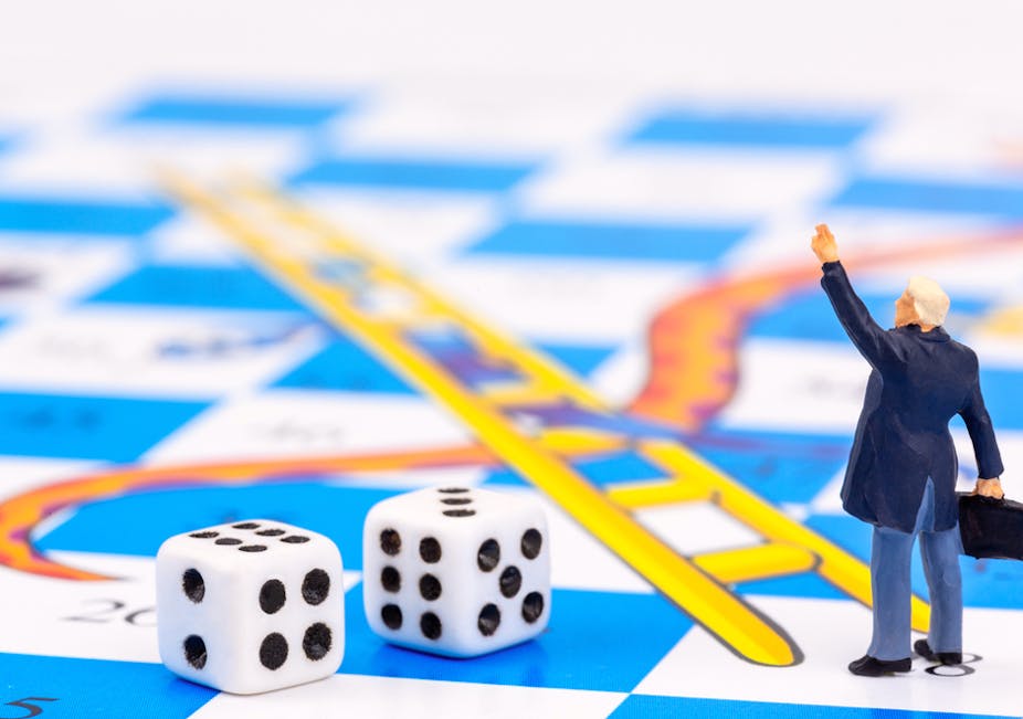 Businessman on a snakes and ladders board