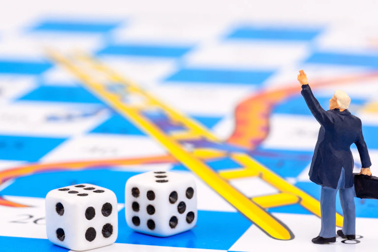 Businessman on a snakes and ladders board