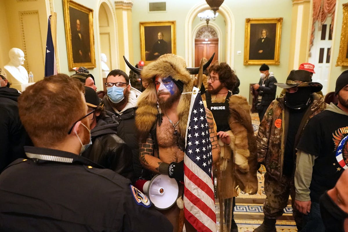 US Capitol riot: the myths behind the tattoos worn by 'QAnon Jake Angeli