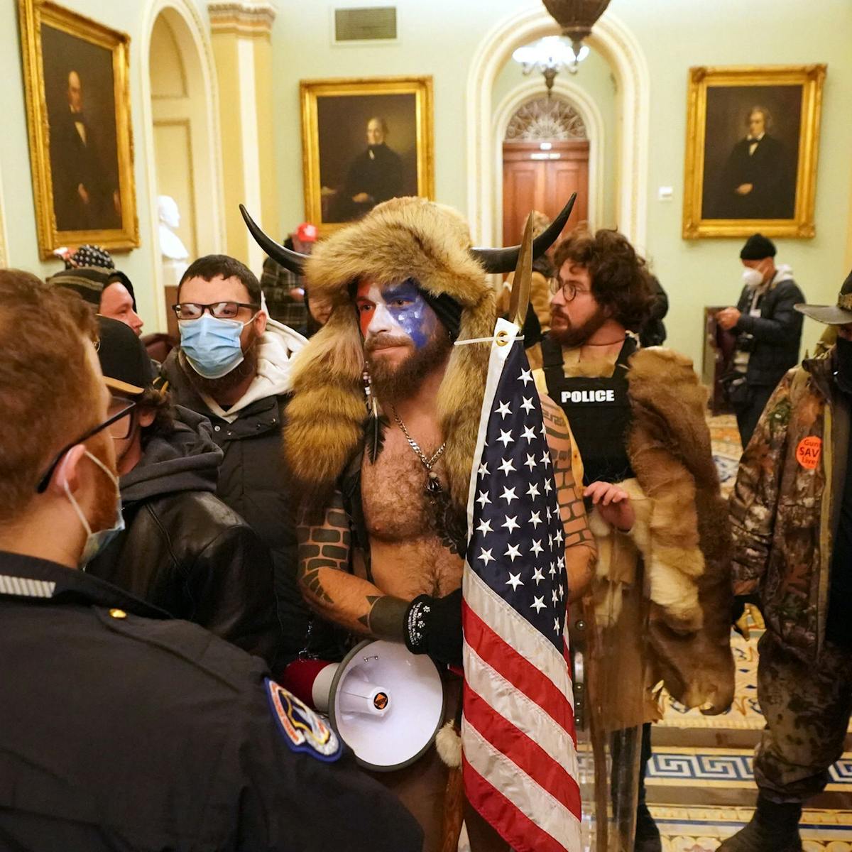 qanon-shaman-meet-the-qanon-shaman-behind-the-horns-at-the-capitol