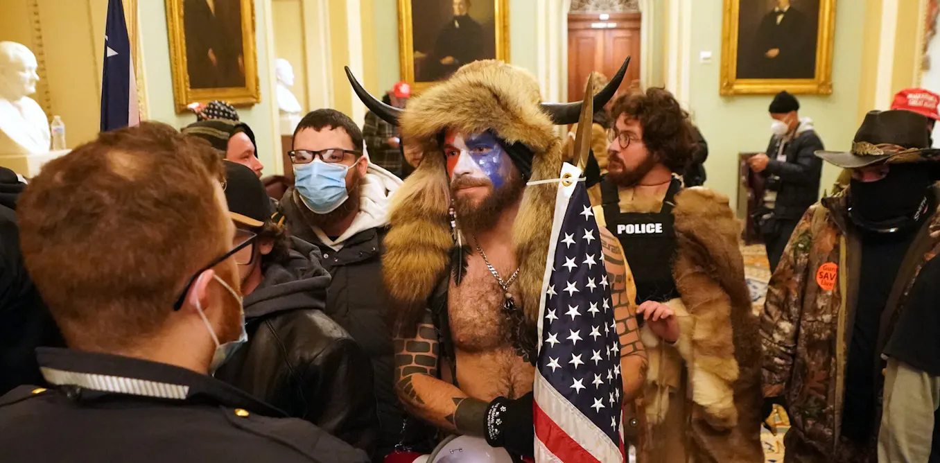 the myths behind the tattoos worn by ‘QAnon shaman’ Jake Angeli the myths behind the tattoos worn by ‘QAnon shaman’ Jake Angeli