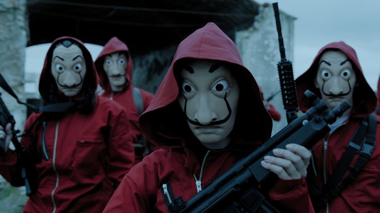 Robbers in red hoodies and masks.