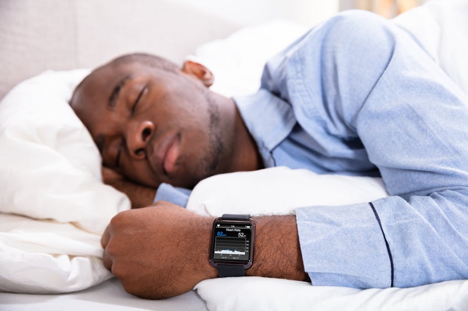 Man sleeping while wearing a smart watch.