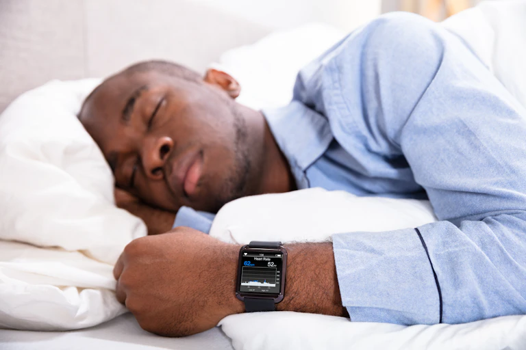 Man sleeping while wearing a smart watch.
