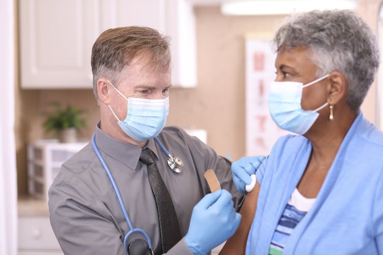 A woman receives a COVID-19 shot.