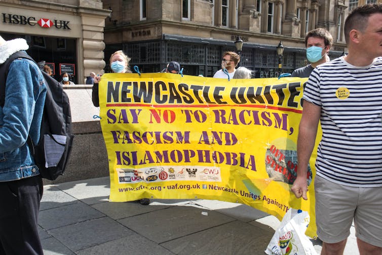 Protestors at a public rally carrying an anti-racism banner on Sept. 5, 2020 in Newcastle, U.K. (Shutterstock)