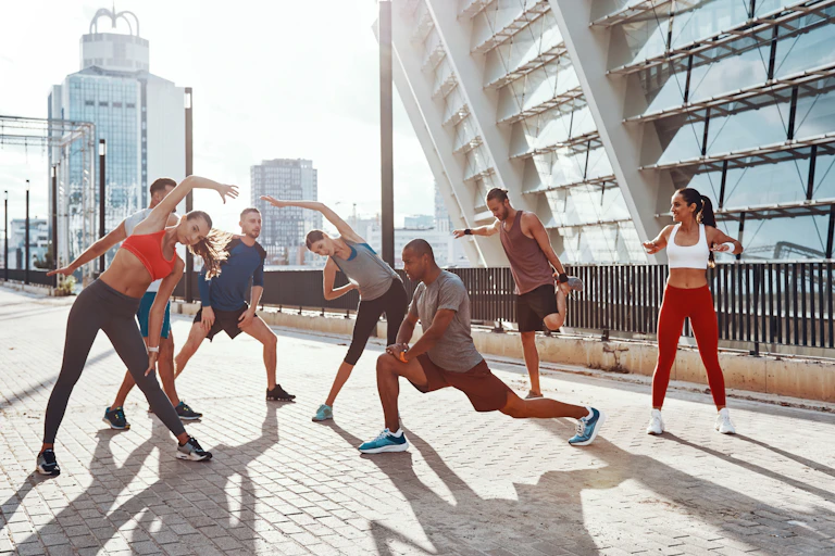 A group of people in athletic clothes warming up