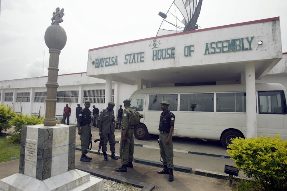 Policemen keeping watch at the entrance of a state assembly in Nigeria 