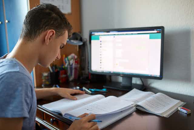 Teenager working in front of computer