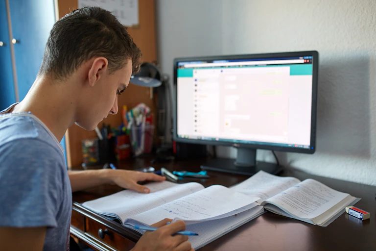 Teenager working in front of computer