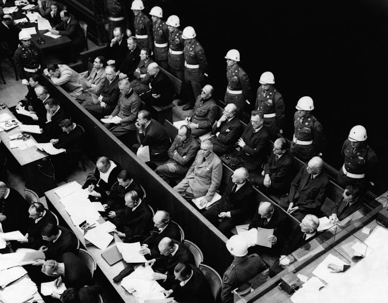 German war crimes defendants sitting in a courtroom at the Nuremberg trials.