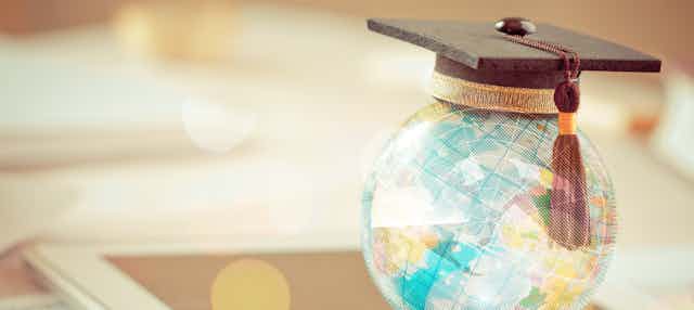 A globe with a graduation cap