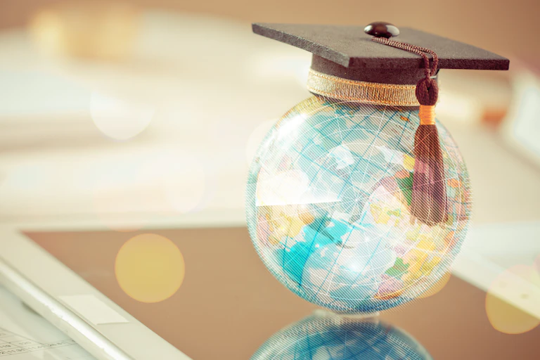 A globe with a graduation cap