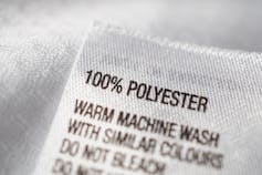 A clothing tag saying 100 per cent polyester