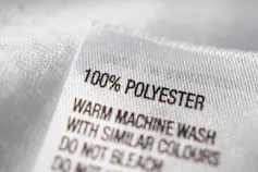 A clothing tag saying 100 per cent polyester