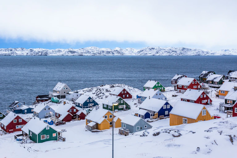 Colourful houses along a fiord outside of Nuuk, Greenland.