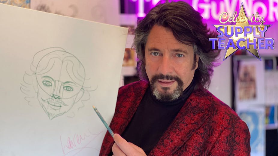 Man with goatee in snake skin blazer points a pencil at a drawing of his face.