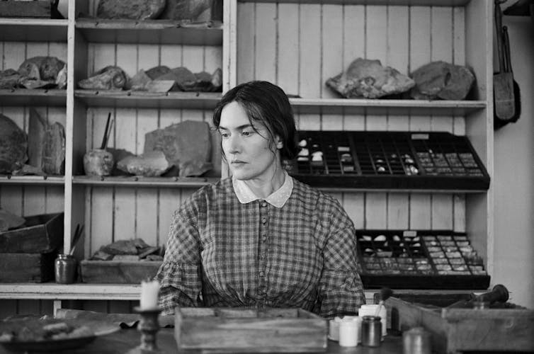Black and white photo of Winslet as Anning.