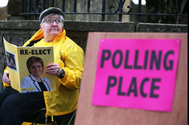 A womam reading SNP election literature 