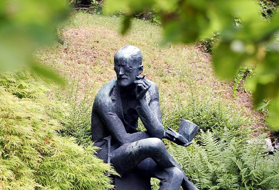 Statue of James Joyce reading at his grave in Zurich, Switzerland.