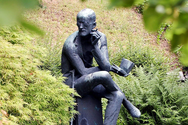 Statue of James Joyce reading at his grave in Zurich, Switzerland.