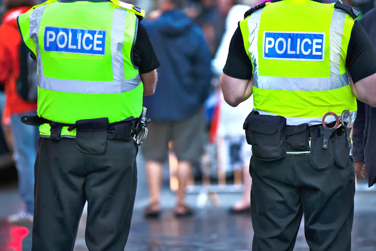 Police in uniforms and high vis jackets with