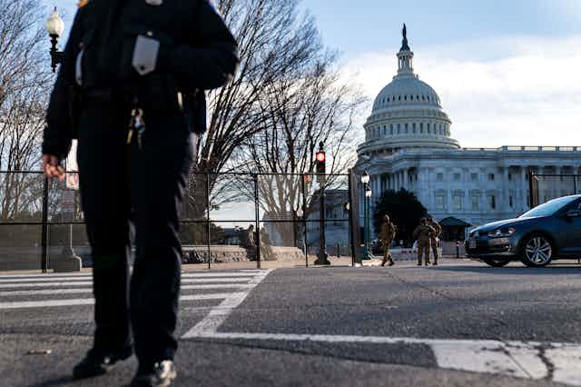 A U.S. Capitol Police Officer stands at a street corner near the U.S. Capitol as heightened security measures are put in place around the U.S. Capitol Building a day after a pro-Trump mob broke into the nations capitol while Congress voted to certify the 2020 Election Results.