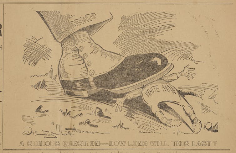 A racist political cartoon by Norman Jennett showing a
        boot worn by a Black man smashing a white man underneath.