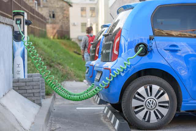 Electric car Volkswagen e-Up charging its batteries on a parking. Spark car sharing service in Lithuania.