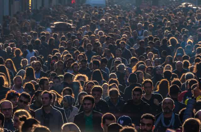 An image of many people crowded close together. 