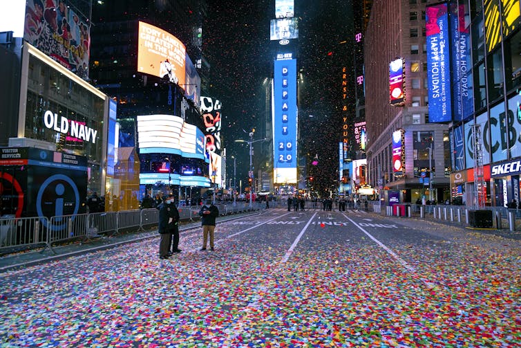 Times Square in New York City is nearly empty on Jan. 1, just after midnight, as celebratory confetti covers the street.