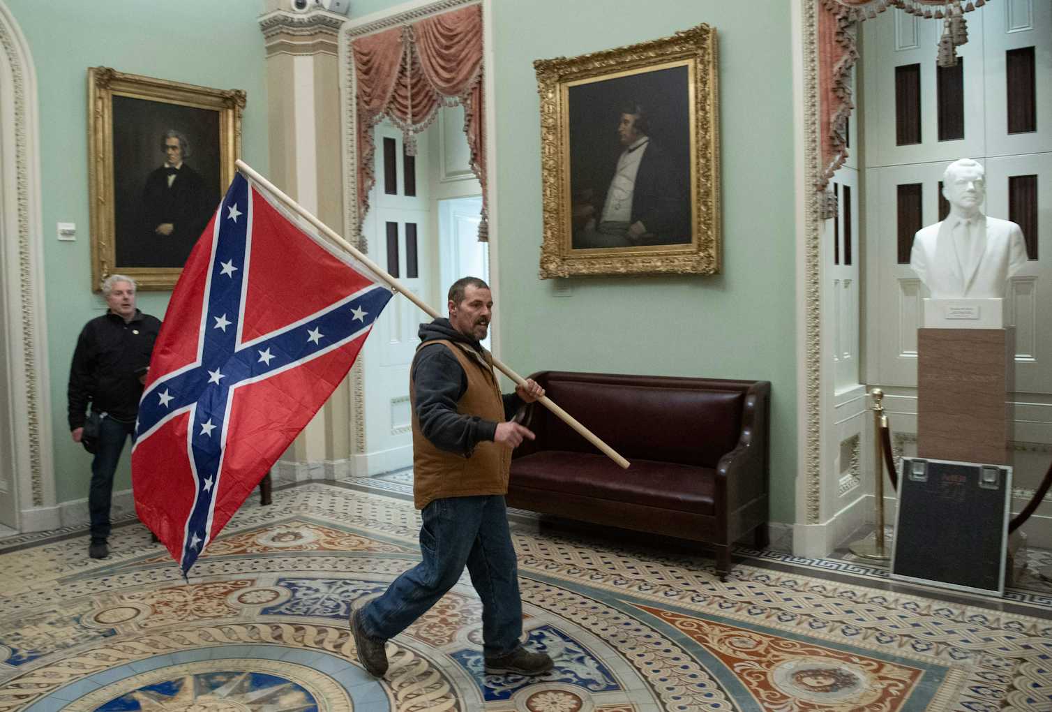 A Man Sits On A Chair Supported By A Rope Symbols of white supremacy flew proudly at the Capitol riot – 5