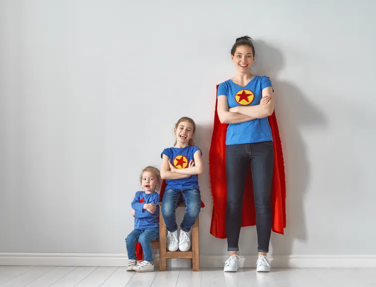 Image of a mum and two kids dressed as superheroes.