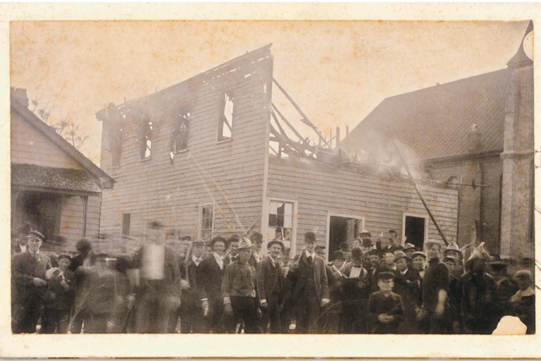 An armed mob of white insurrections in front of the Black newspaper building they burned.