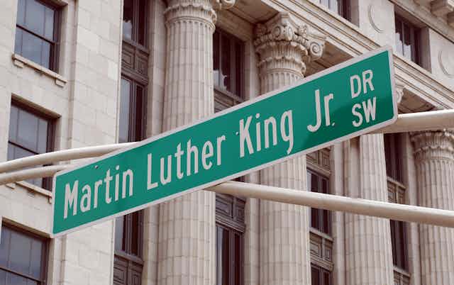 Street sign reading Martin Luther King, Jr. Dr SW in front of columned building