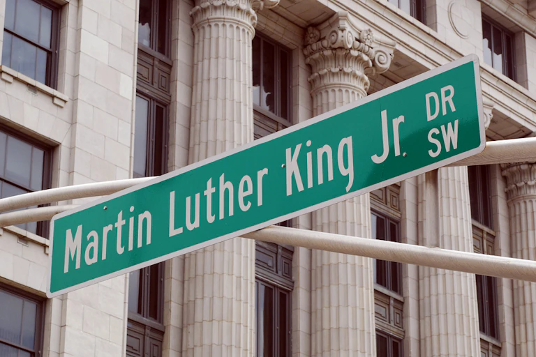 Street sign reading Martin Luther King, Jr. Dr SW in front of columned building