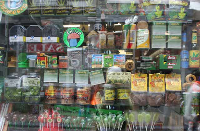 A store window with colourful cannabis packaging on display.