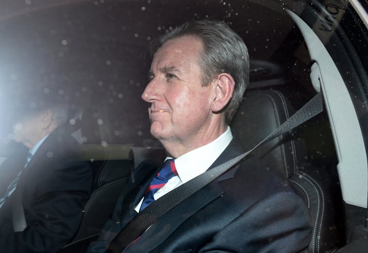 Former NSW premier Barry O'Farrell in the back seat of a car.