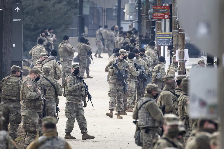Armed troops in fatigues patrolling the streets of Washington DC.
