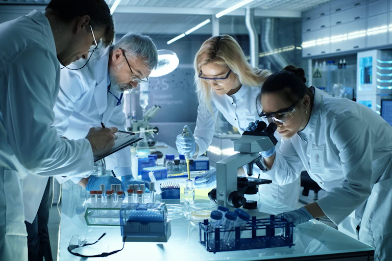 Team of four scientists in lab researching