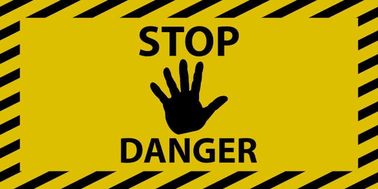 A yellow and black 'stop danger' sign.
